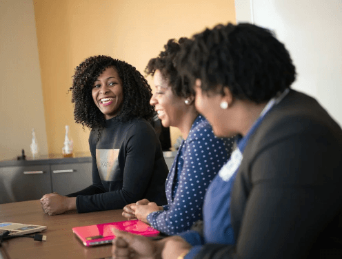 Black professionals reviewing work together
